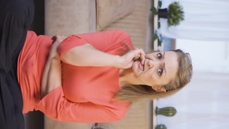 Vertical-video-of-The-woman-is-biting-her-nails.